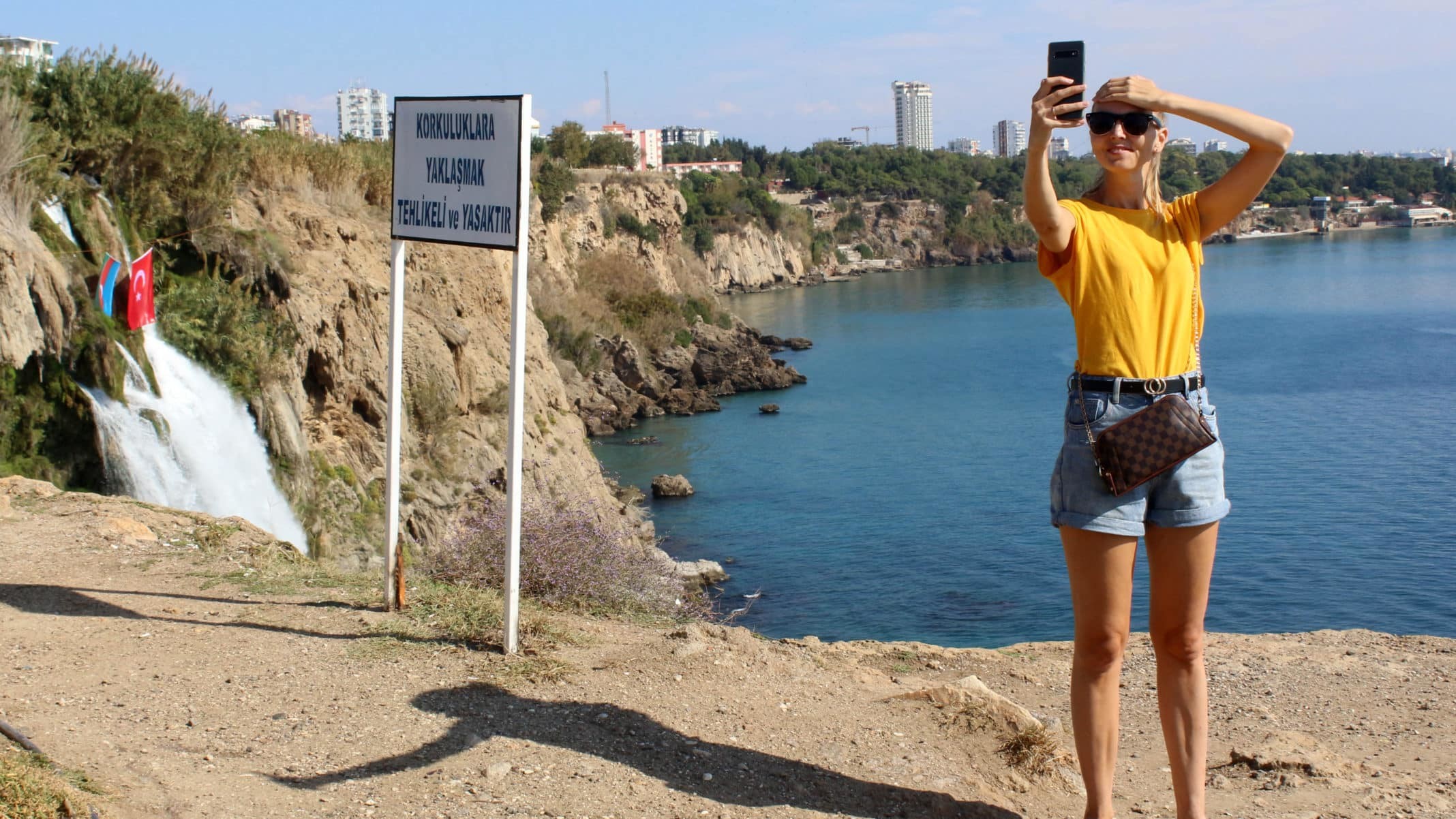Antalya'da Düden Şelalesi'nin denizle buluştuğu noktaya gelen yerli ve yabancı turistler, 'Yaklaşmak tehlikeli ve yasaktır' uyarı tabelasına aldırış etmeden hayatlarını tehlikeye atıyorlar.
