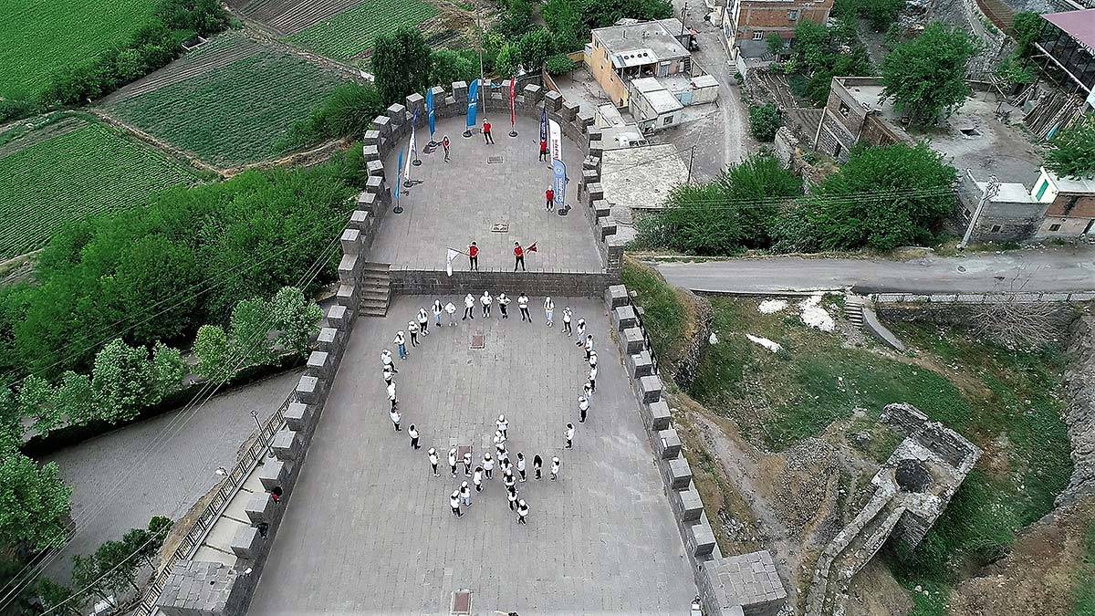 40 genç sporcu 5 bin yıllık tarihi surlarda ay yıldız koreografisi oluşturarak, İstiklal Marşı okudu.