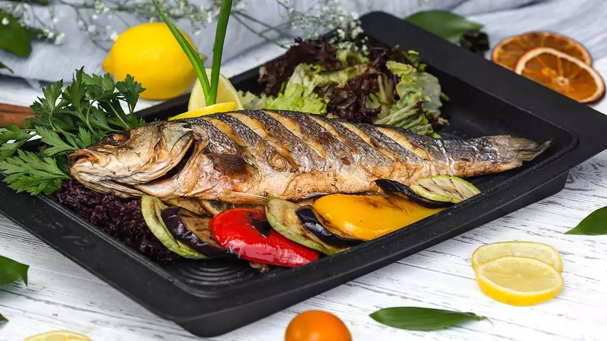 Roasted fish garnished with lemon slices served with vegetables - yazarlar - haberton