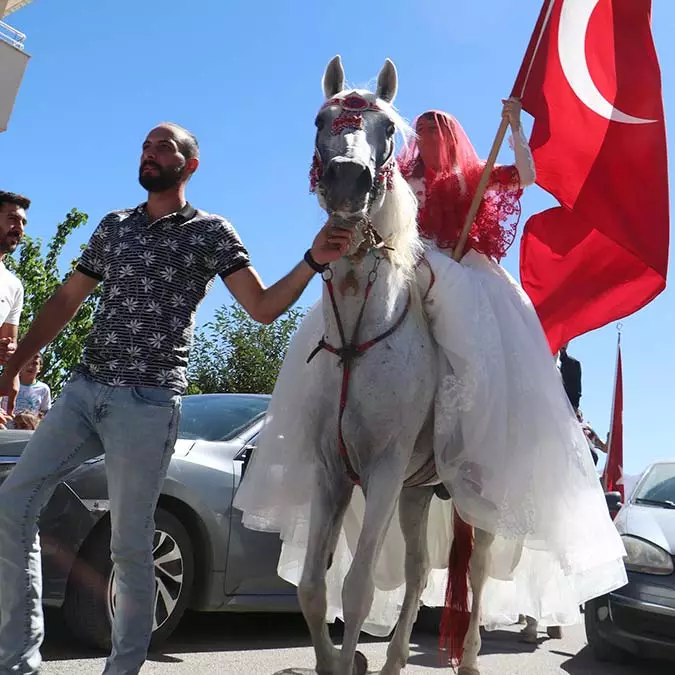 Erzurum'da sınıf öğretmeni ve aynı zamanda kızıl elma geleneksel sporlar ve atıcılık kulüp başkanı ayşe melek okuyucu (41), turnuvalara katıldığı boksör adlı beyaz atına gelin olarak bindi.