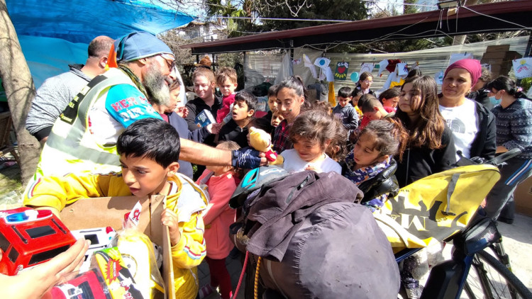 Gazeteci Kemal Yücel bisikletiyle oyuncak dağıtıyor