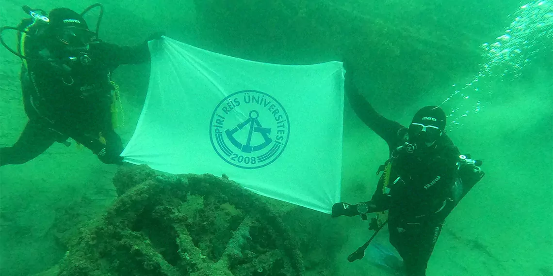 Piri reis üniversitesi öğrencileri çanakkale şehitlerine saygı dalışı gerçekleştirdi, öğrenciler su altında türk bayrağı açtı.