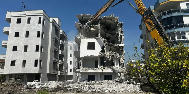 Erdemli'de yan yatan bina yıkılıyor