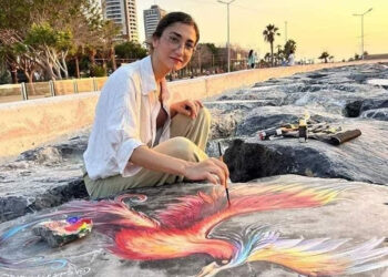 Depremzede ressam sahildeki kayalara renkli figürler çiziyor
