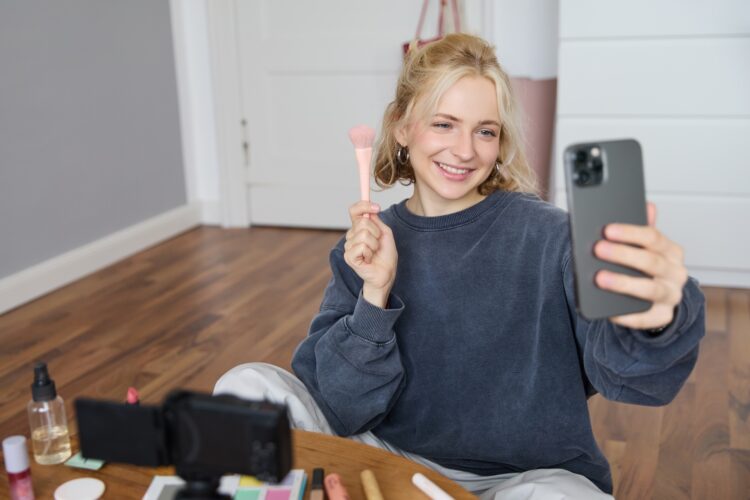 Image of stylish young woman, social media influencer, taking pictures on mobile phone, doing makeup tutorial for followers online, recording video vlog in her bedroom, showing brush. SSUCv3H4sIAAAAAAAACpySyW7DIBCG75X6DhbnWMI2dkhfpephWByjEIgAp6qivHtZ7IheK3Fgvpn5Z4HH+1vTIAZecfTRPJIVbaX16oODoKyJGB827qQR0tXk7oYJ1wBUbUmhgnUKdA0ZBL4YuMoIzap1ws/sRD5AWL30qZcNcQjyHDUKfEmUhj+L3eyO7IwZ0YXQoWJ+ZZntqIj/K7Ncvl4Dn6XhP7nhahAntYQyyNYjEuPMOoJpywAfWzKdSEvxkbacyn7C7NQJMucqRRpdvoN013oVsAplqy3cLQedAoaqMqgbOPiTd3OKK3OuiA1LfsddidvVBJemeA2PtLU3YDq90hzLyJ0v4H0MFzuvavP4a+y1qmNsyDvYVJGIj5nMbhjGcTrSYTiOtI8HbwHlAywq6uR2dqFo84sS9VQqdYDIifAJE2jpLOJW565voZ/ijRHJ5TzRsZNxq89fAAAA//8DAIlXss7pAgAA