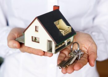 A closeup shot of a person thinking of buying or selling a house