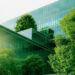 Sustainble green building. Eco-friendly building. Sustainable glass office building with tree for reducing carbon dioxide. Office with green environment. Corporate building reduce CO2. Safety glass.
