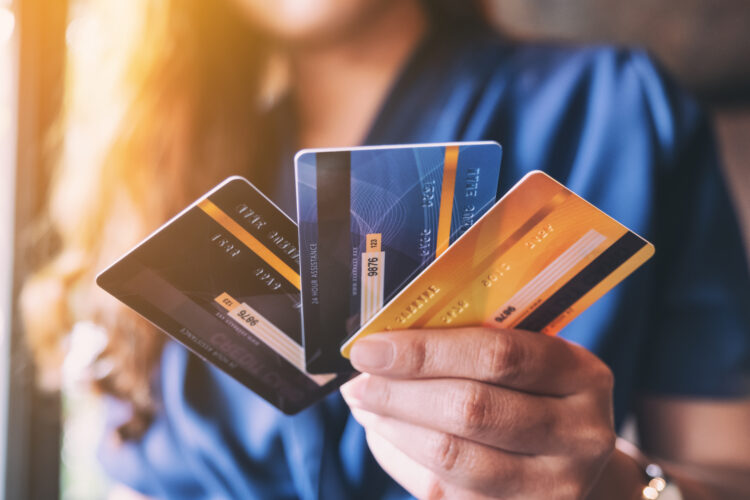Closeup image of a woman holding and showing credit card