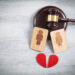 Concept of divorce. Male and female wooden symbols, red heart and judge gavel